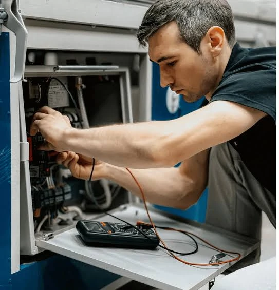 Illustrative technician inspecting the electrical components of an HVAC unit