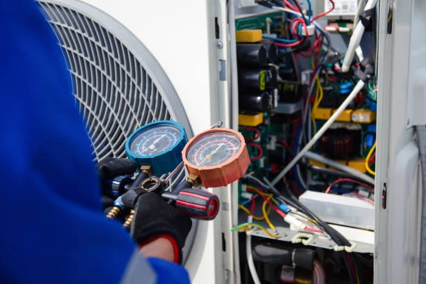 Illustrative technician checking HVAC refrigerant pressure with manifold gauges